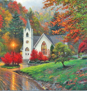 White church in a colorful autumn landscape beside a wet road
