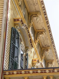 Ornate interior ceiling and walls with decorative moldings and panels in cream and gold