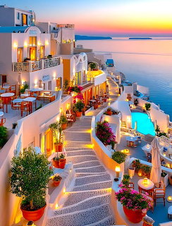 Santorini white buildings with lit terraces, flowers, pool, and ocean view at sunset