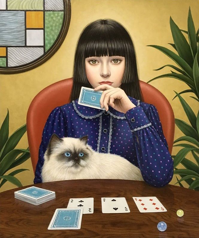 Woman with dark hair holding playing card at table with fluffy cat, cards and chips, stained glass window behind