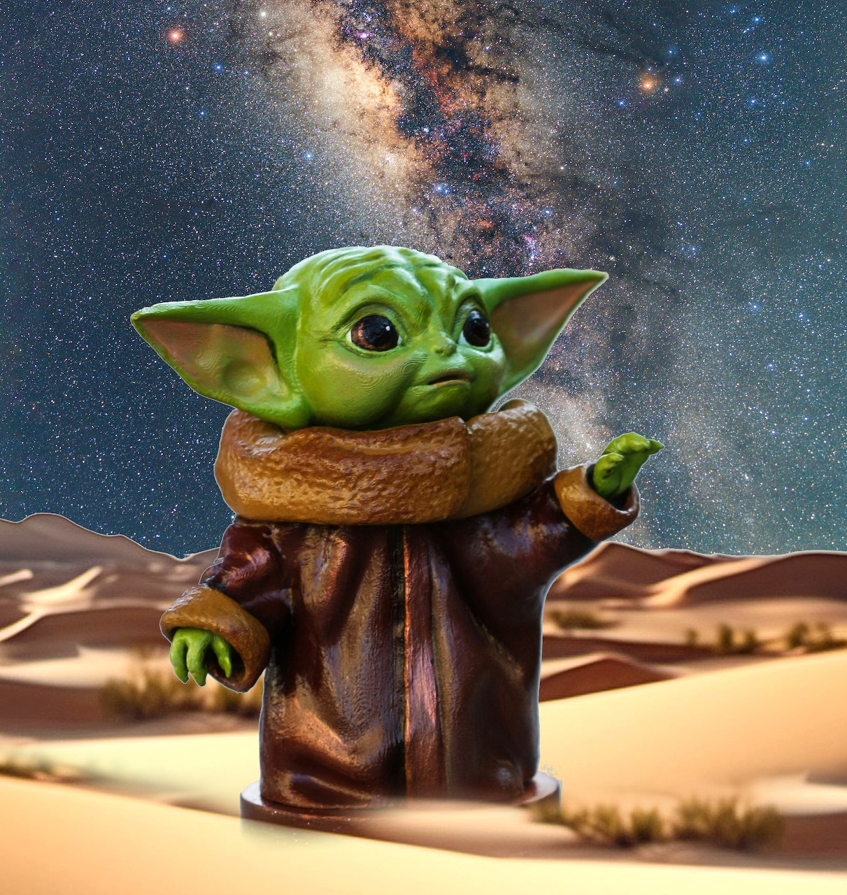Baby Yoda toy in desert sand under a starry Milky Way sky