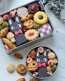 Colorful cookies decorated as Totoro characters and various shapes in metal tins