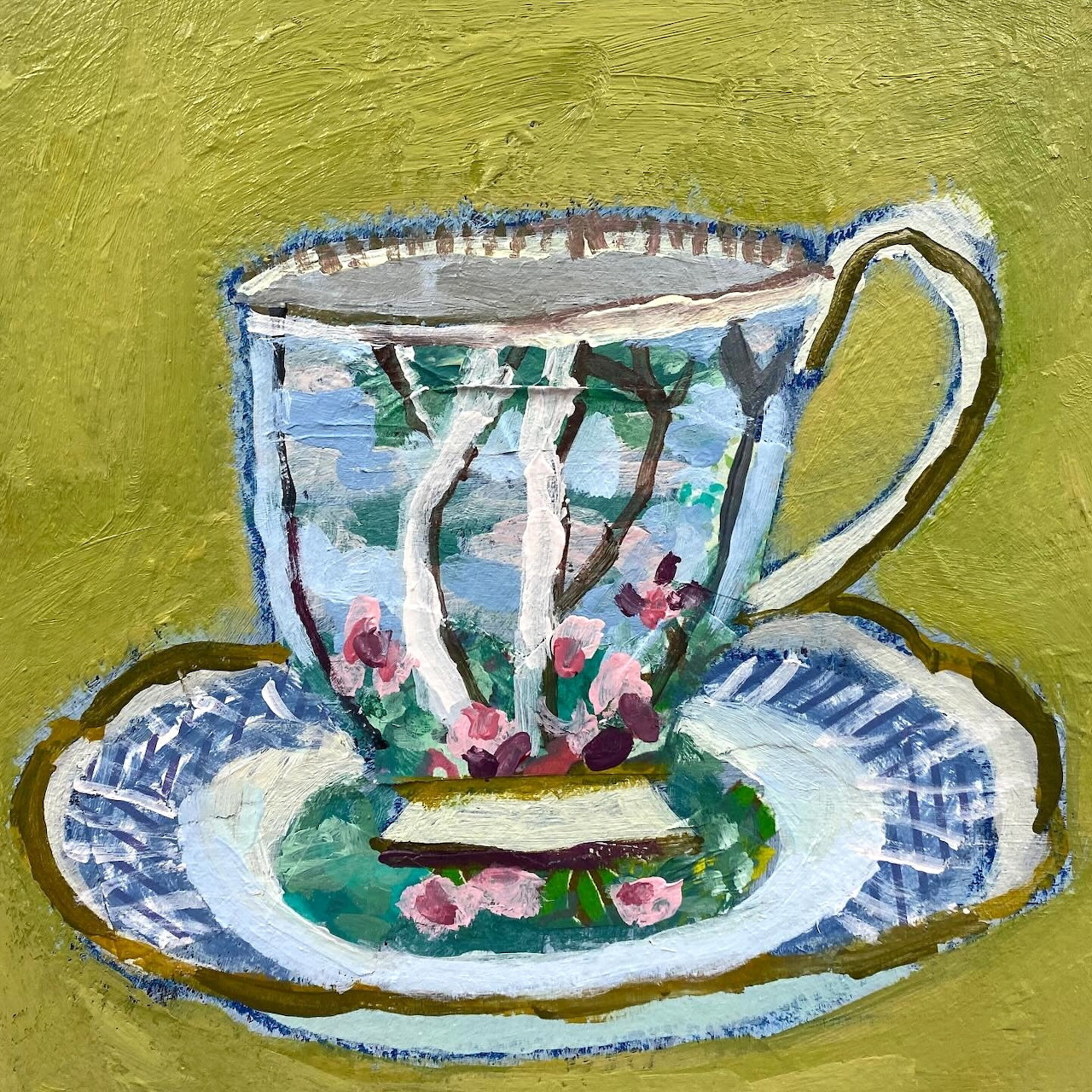 Painted teacup and saucer with pink flowers and green leaves on golden background