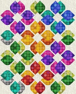 Colorful quilt with diamond-shaped blocks in rainbow hues arranged in a grid pattern on white fabric