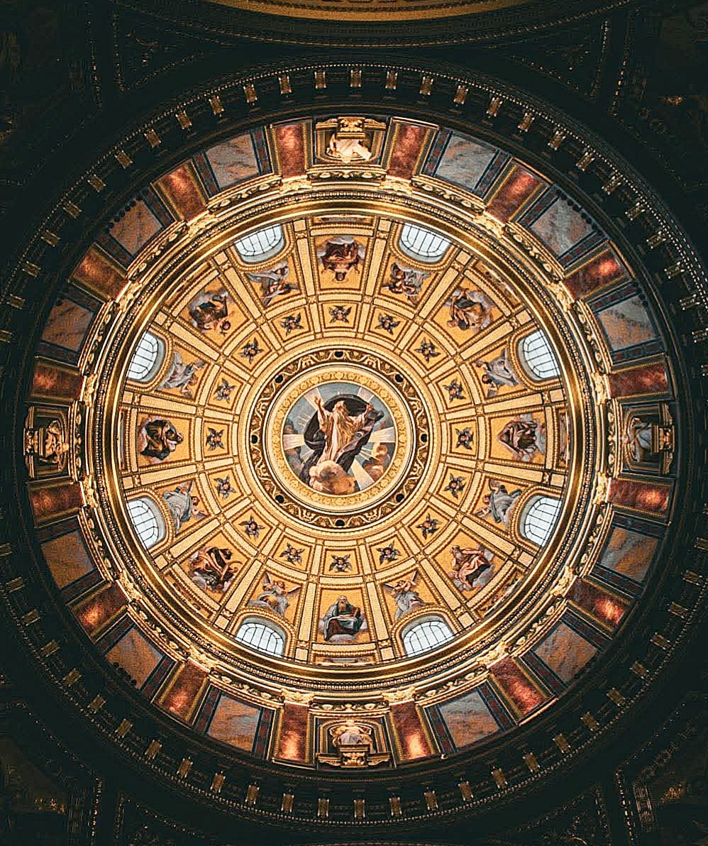 Ornate baroque dome ceiling with golden frescoes and religious paintings in concentric circles