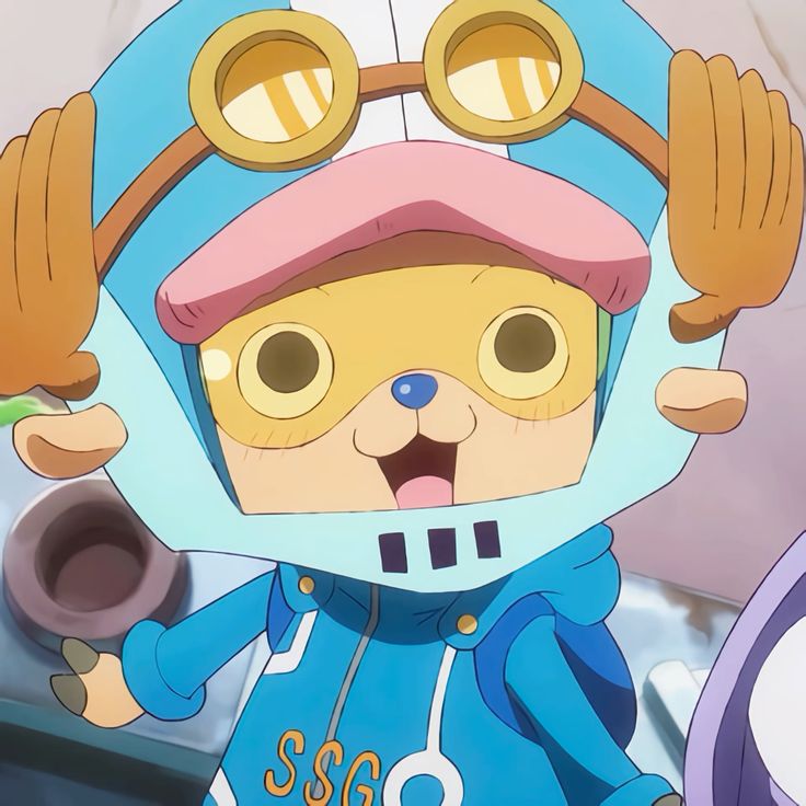 Tony Tony Chopper anime character smiling in blue costume with pink hat and round goggles