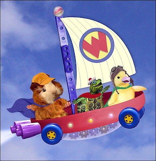 Animated hamster, turtle, and duck riding a red flying sailboat with a 'W' logo sail in the sky