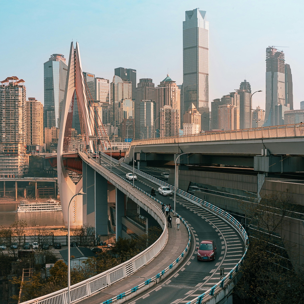 Curved highway overpass ramps with city skyline in background