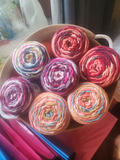 Bowl of colorful multicolored yarn balls in pink, purple, blue, and pastel shades