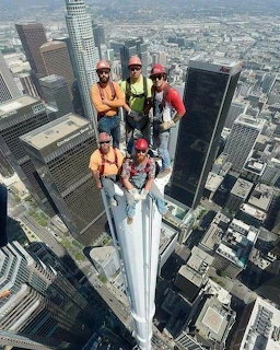 Construction Workers on Skyscraper Top