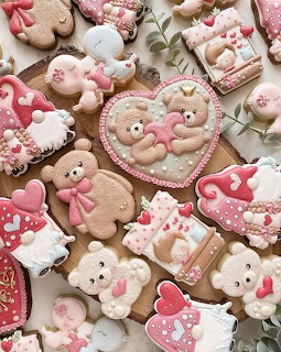 Assorted Valentine's Day decorated sugar cookies with teddy bears and hearts in pink, white, and beige frosting