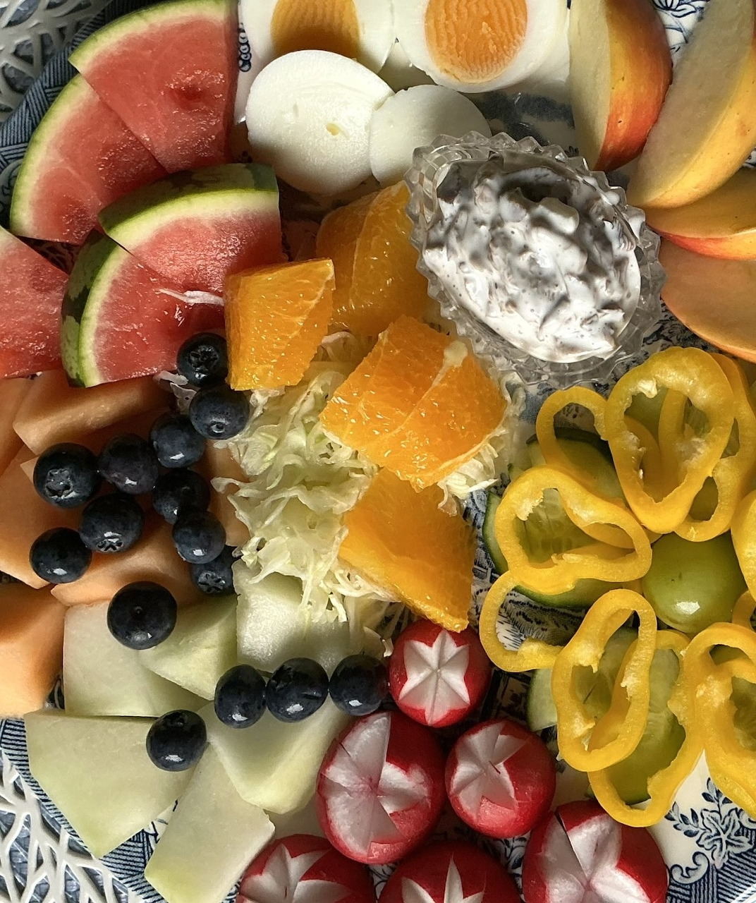 Colorful arrangement of fresh mixed fruits including apples, oranges, grapes and berries.