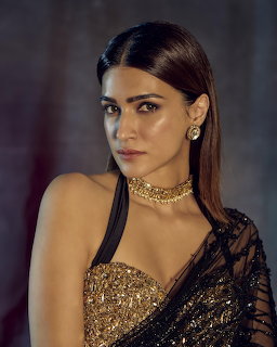 Kriti Sanon in a gold sequin saree with choker necklace and drop earrings
