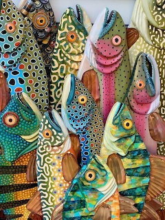 Decorative fish collage art with colorful patterns, polka dots, and textured details