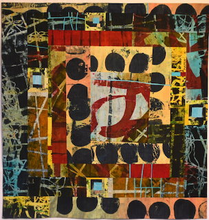 Abstract quilt artwork with geometric blocks, black circles, and stitched textures in earthy tones