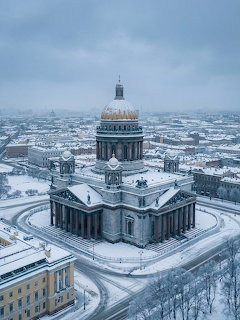 Snow-covered Saint Isaac's Cathedral with golden dome in winter aerial cityscape view