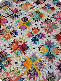 Colorful patchwork quilt with geometric star and triangle blocks