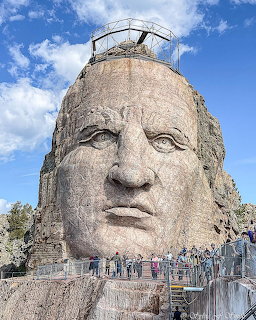 Crazy Horse Memorial mountain carving with visitors on a viewing platform below
