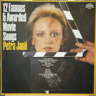 Vintage Petra Jani album cover with a woman's face behind a film clapperboard