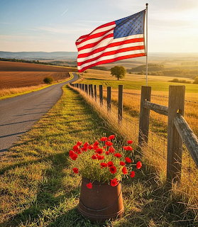 American flag on a wooden fence post with red tulips in a barrel along a country road at sunset