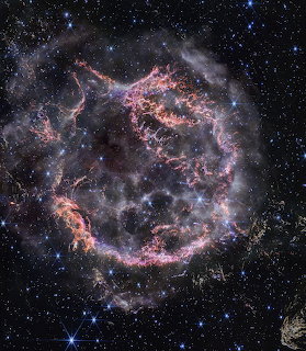 Cassiopeia A supernova remnant captured by James Webb Space Telescope with colorful gas filaments and stars