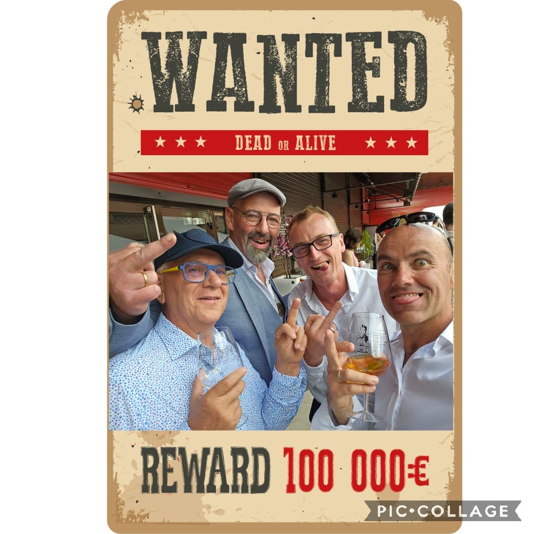Four smiling men taking a selfie inside a vintage wanted poster frame
