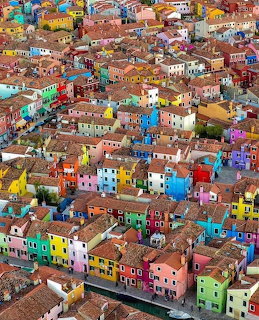 Aerial view of colorful houses in Burano, Venice, with bright painted facades and red-tiled roofs