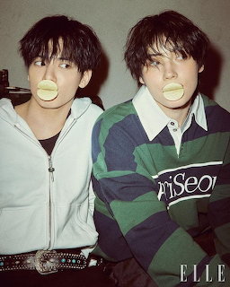 Two young men blowing yellow bubble gum bubbles, posing for ELLE magazine editorial