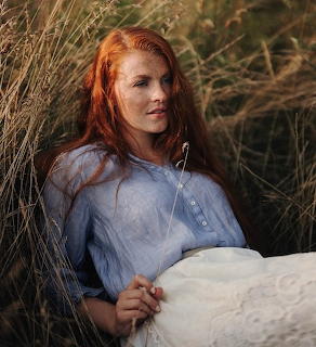 Redhead Woman in Tall Grass