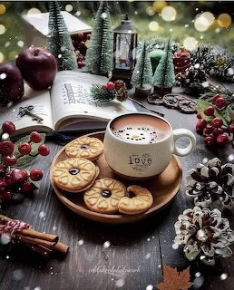 Coffee and cookies surrounded by Christmas decorations and miniature trees with bokeh lights