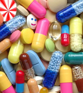 Assortment of colorful pills, capsules and tablets in various shapes, sizes and rainbow colors