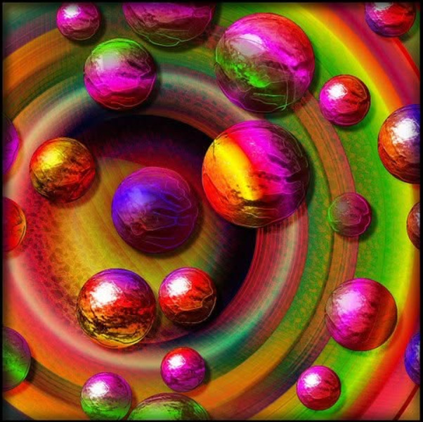 Colorful glossy marbles on a bright abstract spiral background