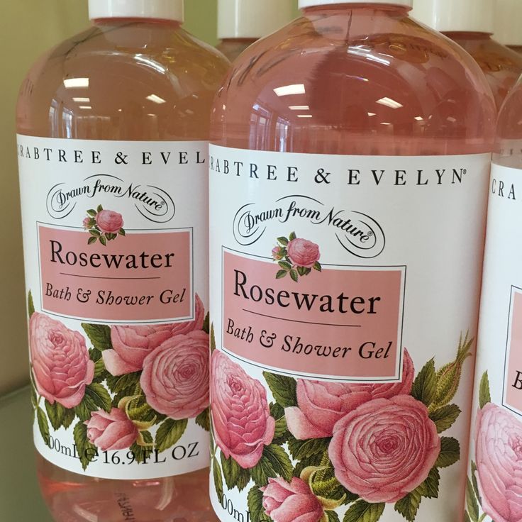 Close-up of rosewater bath and shower gel bottles with pink rose labels