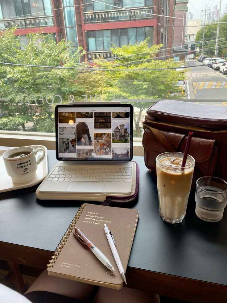 Woman studying with books and coffee at a table in a Korean café