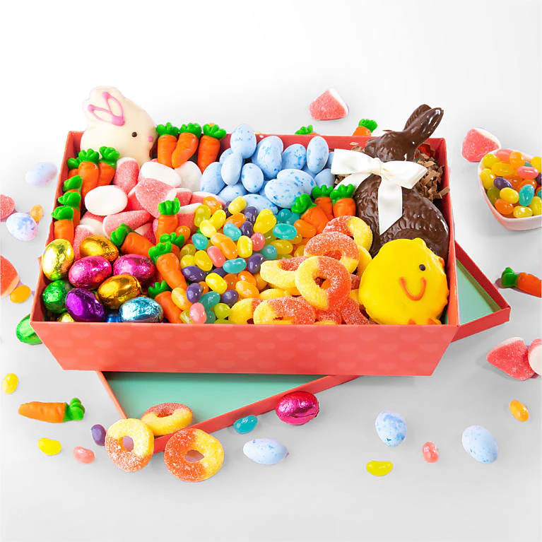 Assorted Easter candy including chocolate bunnies, colorful jelly beans, marshmallow chicks, and wrapped eggs in pink tray