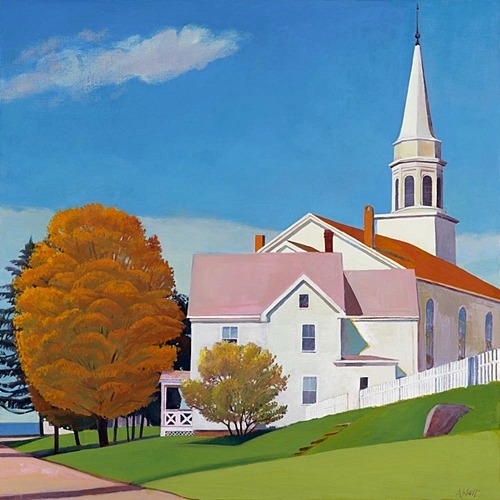 White church with tall steeple next to houses and orange autumn trees on green hillside