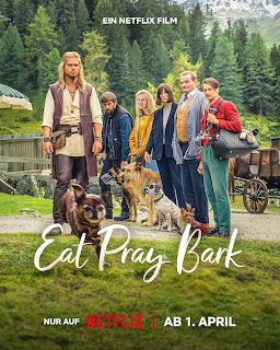 Group of five people standing with three dogs in front of mountains and forest, promotional poster for Eat Pray Bark
