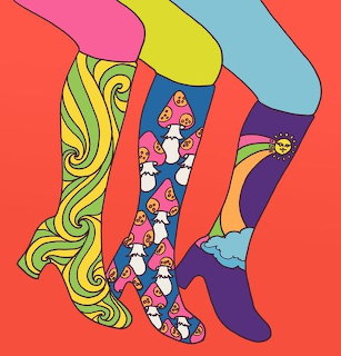 Three colorful patterned boots on a bright coral background