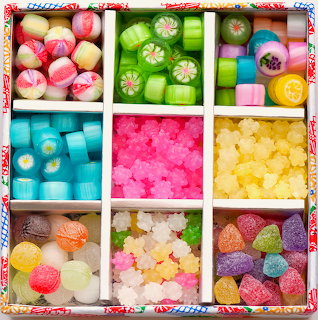 Assorted colorful Japanese candies arranged in a compartmentalized box with various shapes and colors