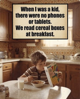 Young boy reading a cereal box at a kitchen table with a bowl of cereal and glass of milk