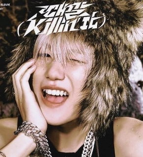 Smiling young man with blonde hair and fur hood posing for a K-pop concept photo