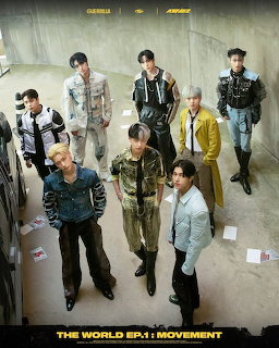 Seven young men posing indoors in a stylized group portrait with modern outfits.