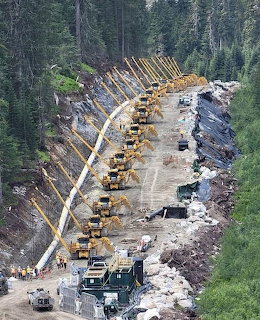 Large gas pipeline being lowered into a trench during installation