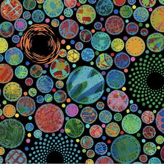 Abstract art with many colorful patterned circles of different sizes on black background