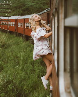 Woman Leaning from Moving Train Window