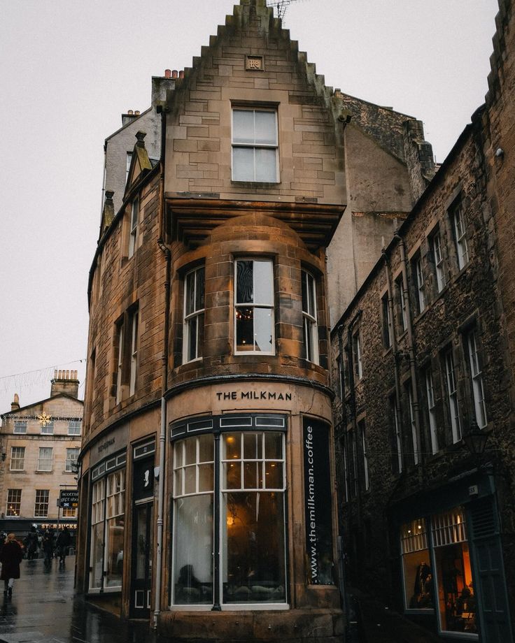 Exterior of The Milkman coffee shop in Edinburgh with dark facade and hanging sign