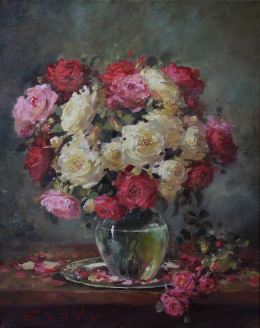 Oil painting of red, pink, and cream roses in a glass vase on a decorated plate with scattered petals