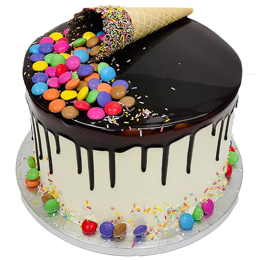 Round cake with black chocolate drip, colorful candies, and waffle cone on top