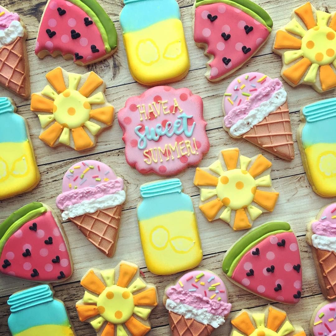 Assortment of decorated summer cookies including watermelon slices, ice cream cones, popsicles, and sun shapes