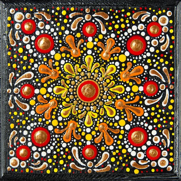 Colorful dot art mandala with orange and red circular motifs radiating from center on black background